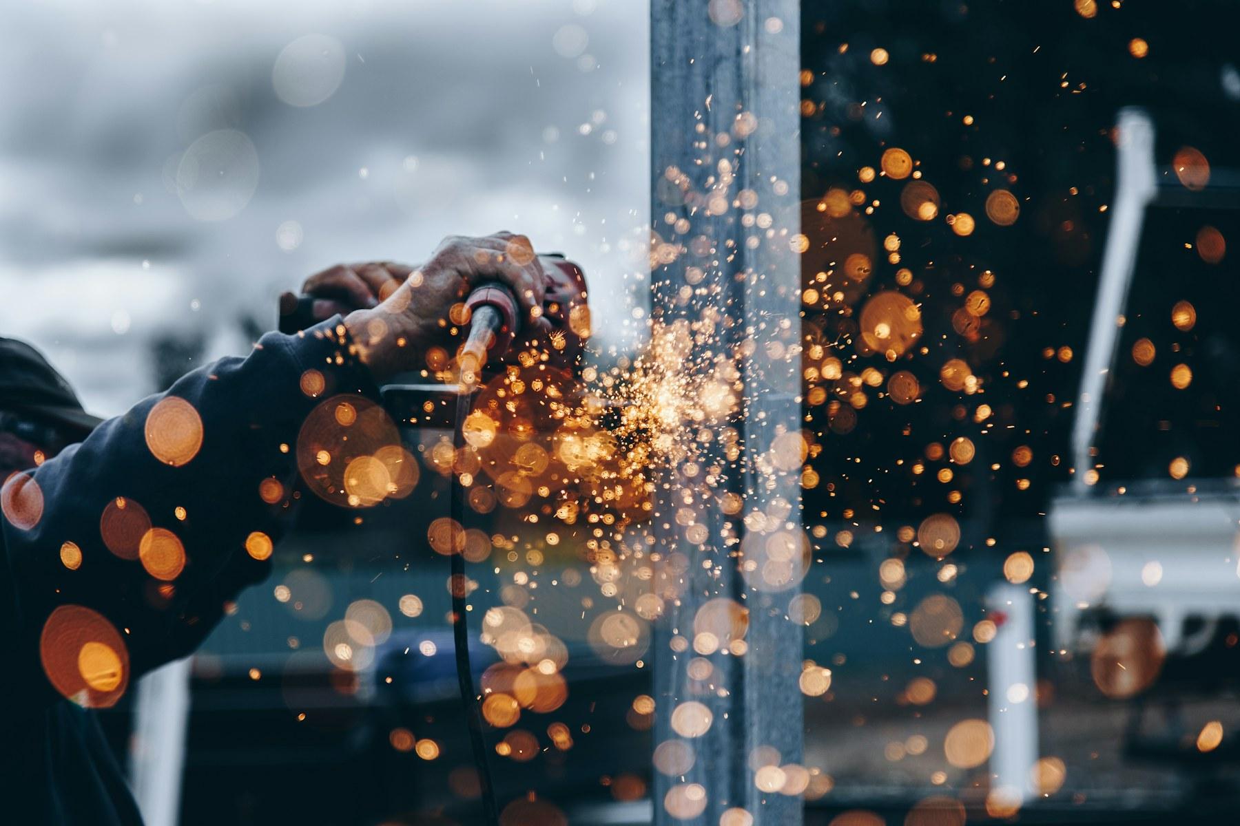 A fabricator working with metal in a workshop